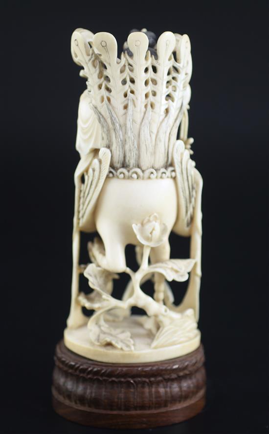 A Chinese ivory figure of the goddess He Xiangu, early 20th century, 21.5cm including wood stand